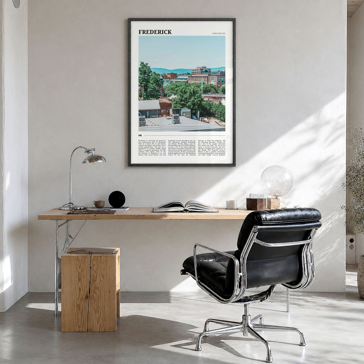 Frederick Travel Poster in a black wood frame, hanging in a bright home office