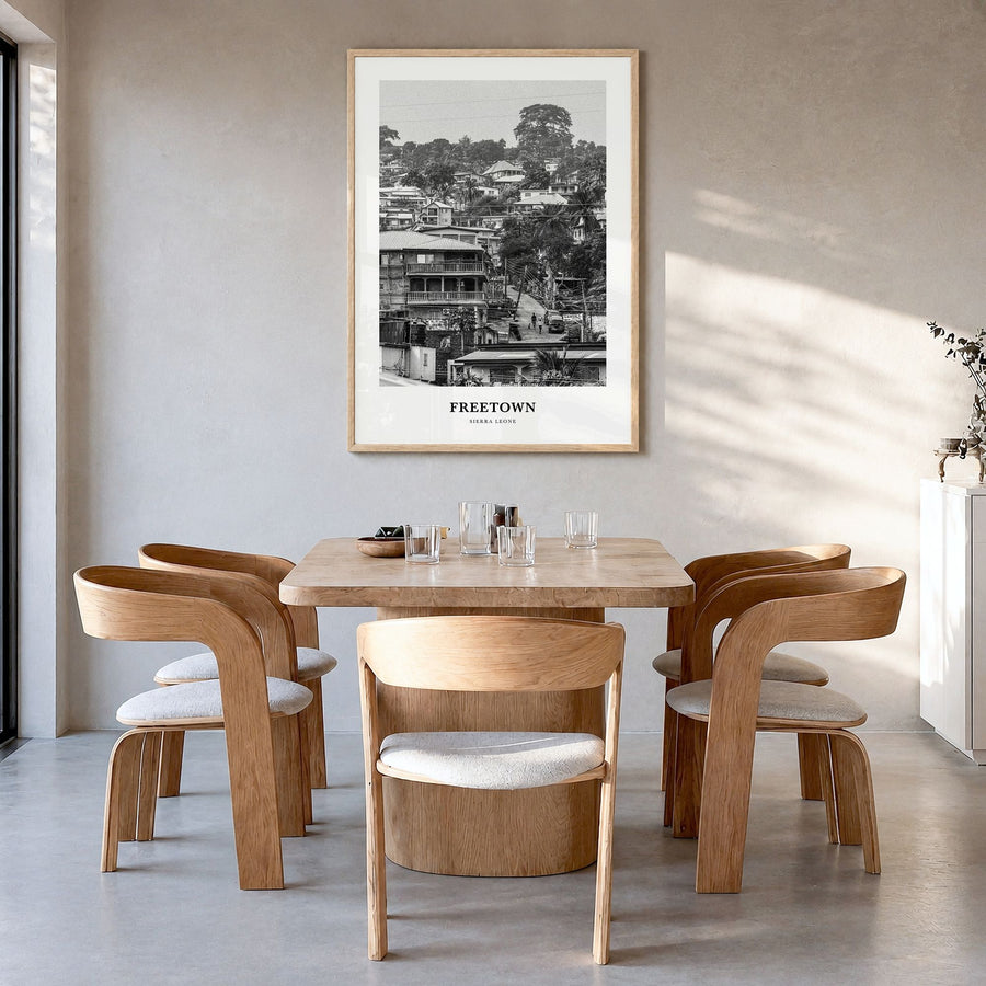Freetown Classic Poster in a natural wood frame, hanging in a dining room