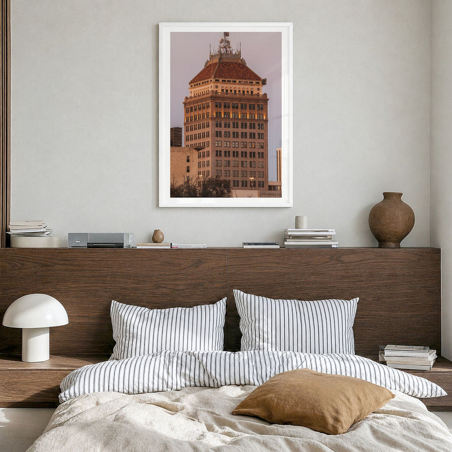 Fresno Photo Poster in a white wood frame, hanging in a bedroom, white border