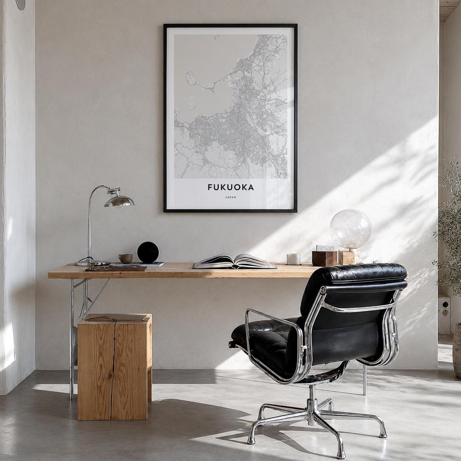 Fukuoka black & white map poster of Japan – vertical wall art in black wood frame, hanging on wall