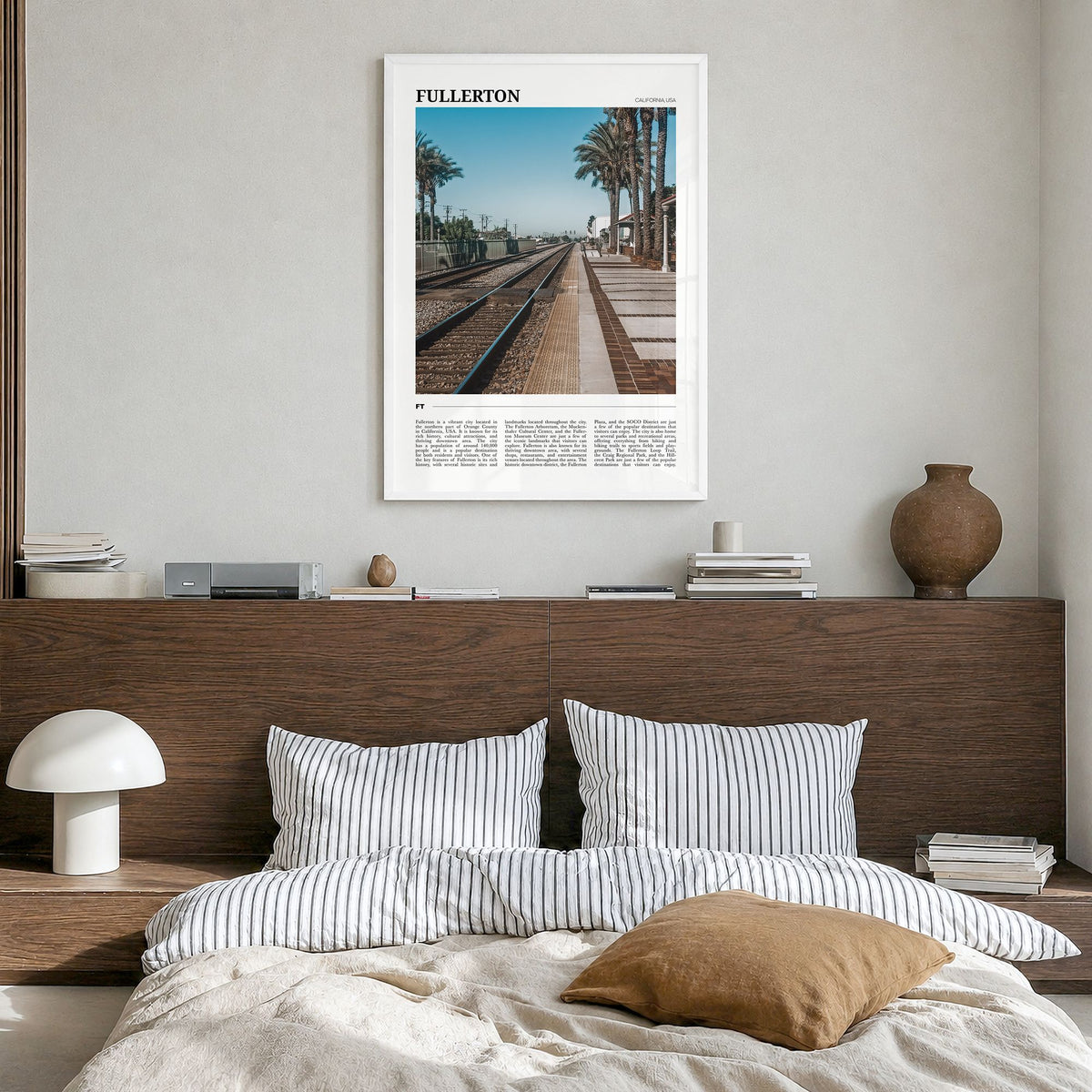 Fullerton Travel Poster in a white wood frame, hanging in a bedroom