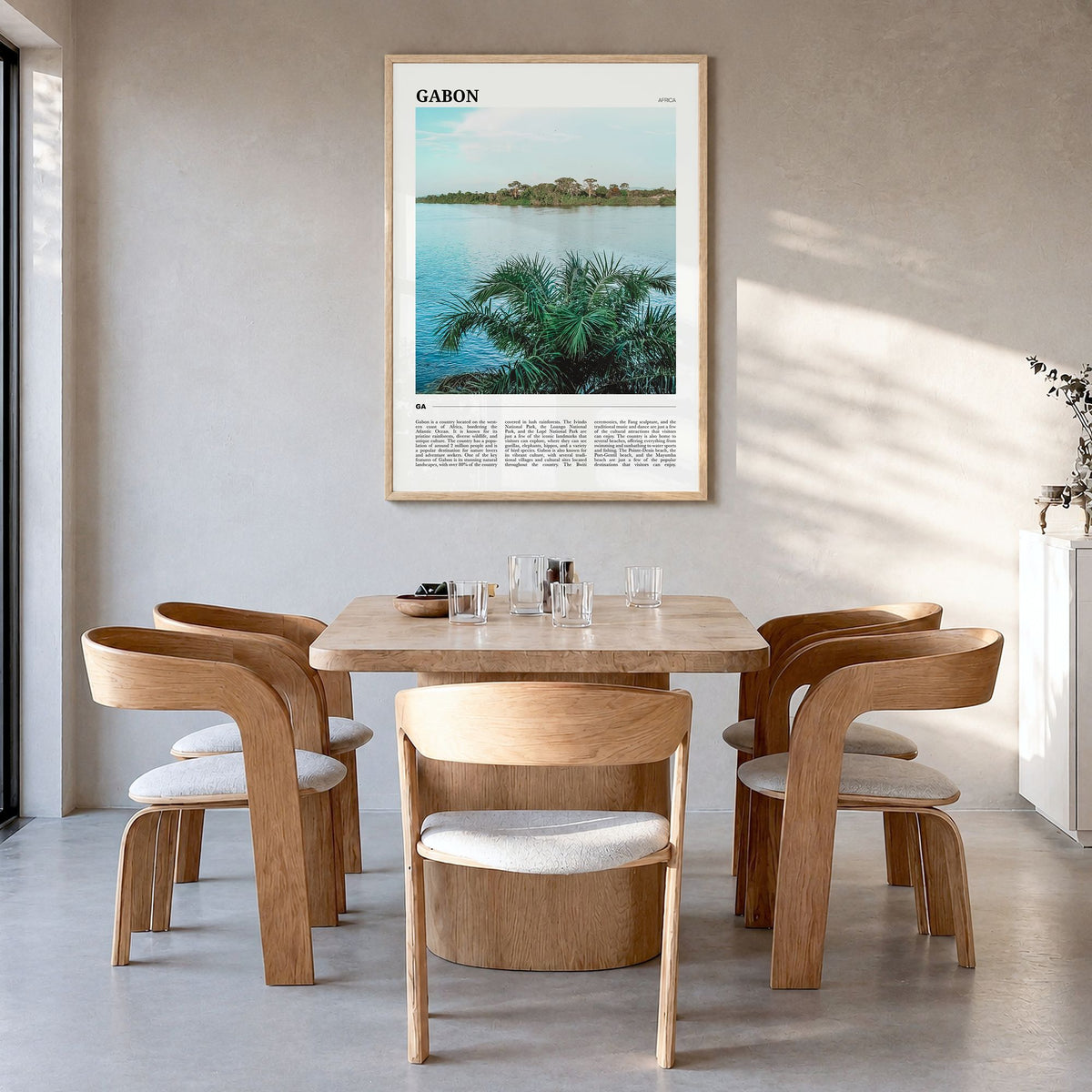 Gabon Travel Poster in a natural wood frame, hanging in a dining room