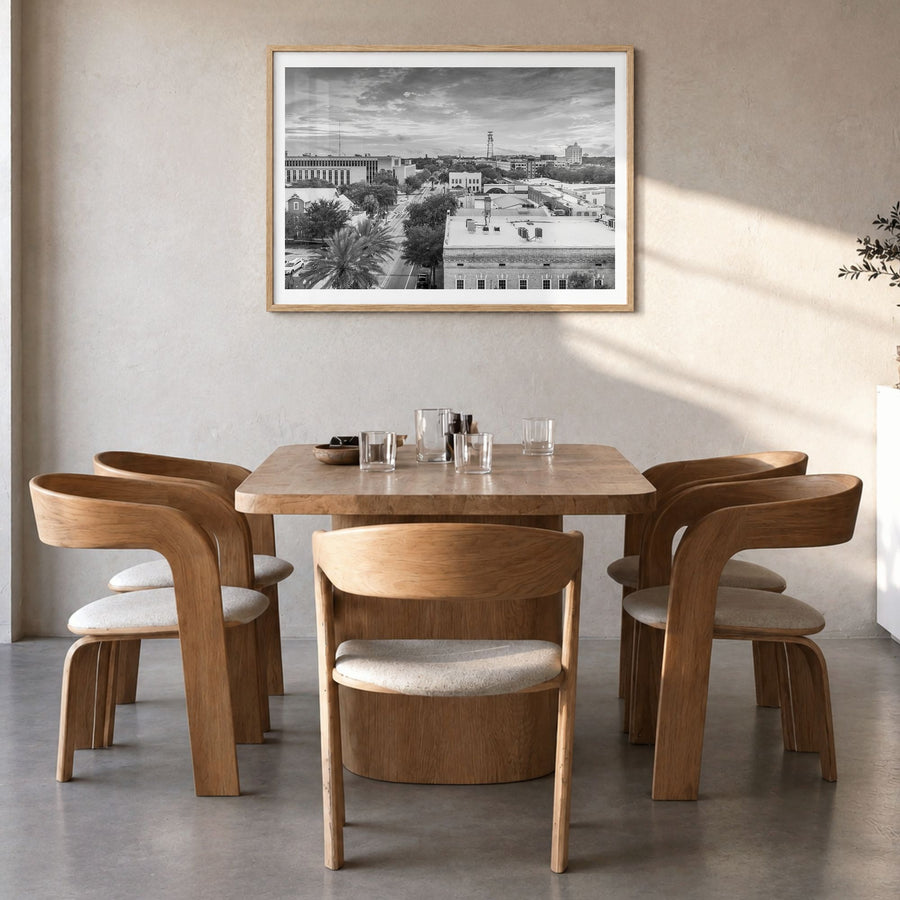 Gainesville Photo Poster in a natural wood frame, hanging in a dining room, white border