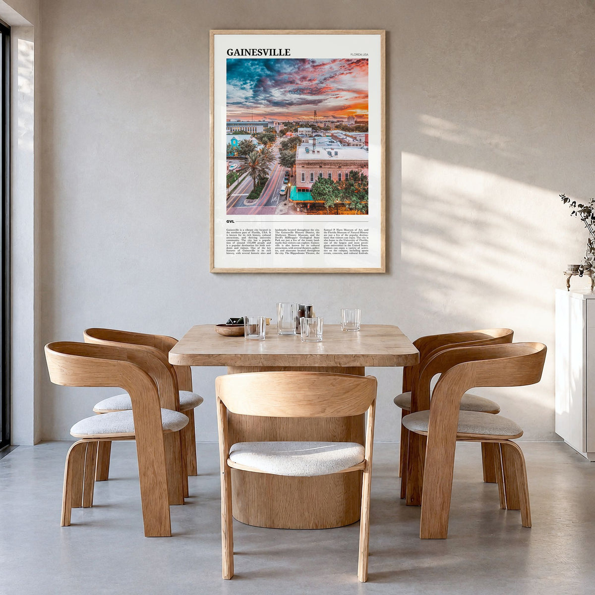 Gainesville Travel Poster in a natural wood frame, hanging in a dining room