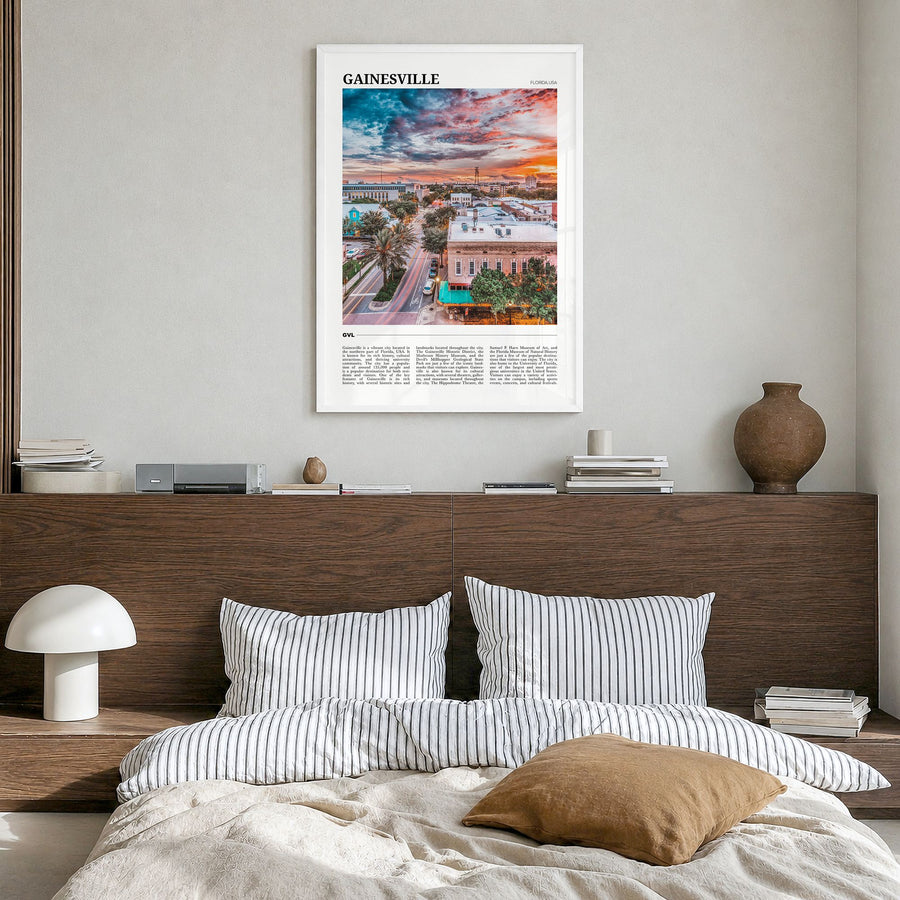 Gainesville Travel Poster in a white wood frame, hanging in a bedroom