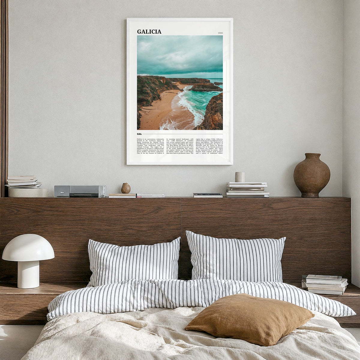 Galicia Travel Poster in a white wood frame, hanging in a bedroom