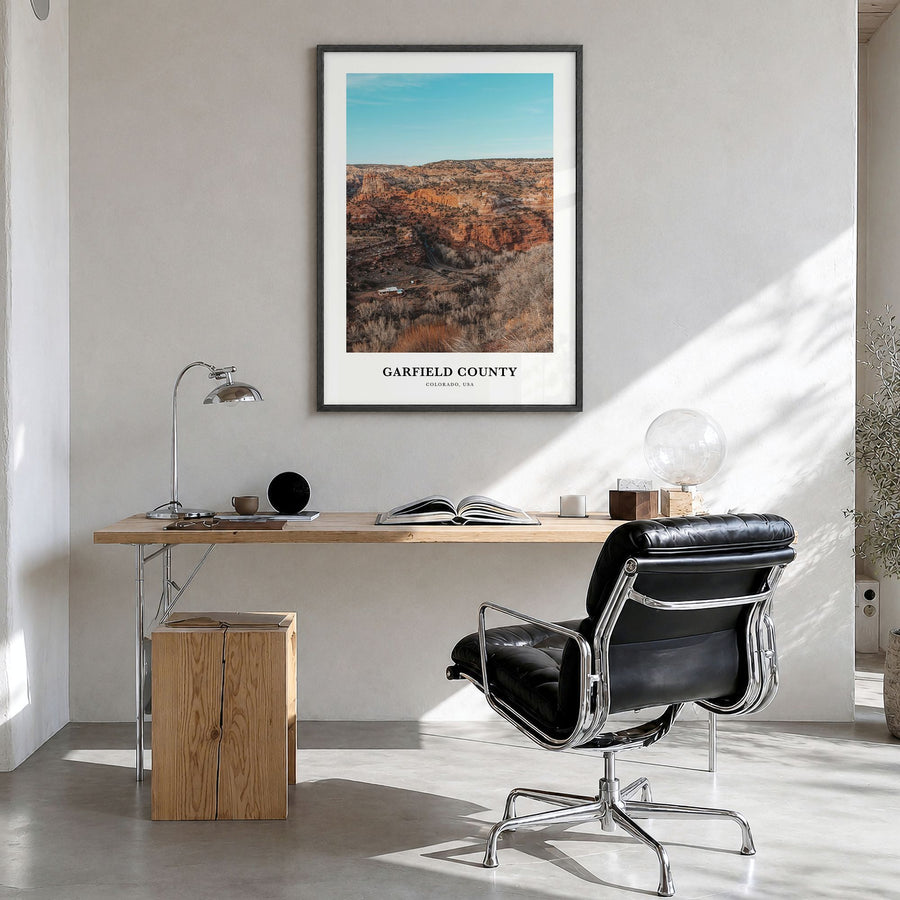Garfield County Classic Poster in a black wood frame, hanging in a bright home office