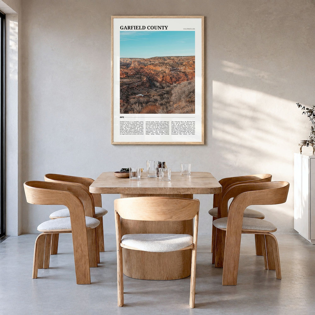 Garfield County Travel Poster in a natural wood frame, hanging in a dining room