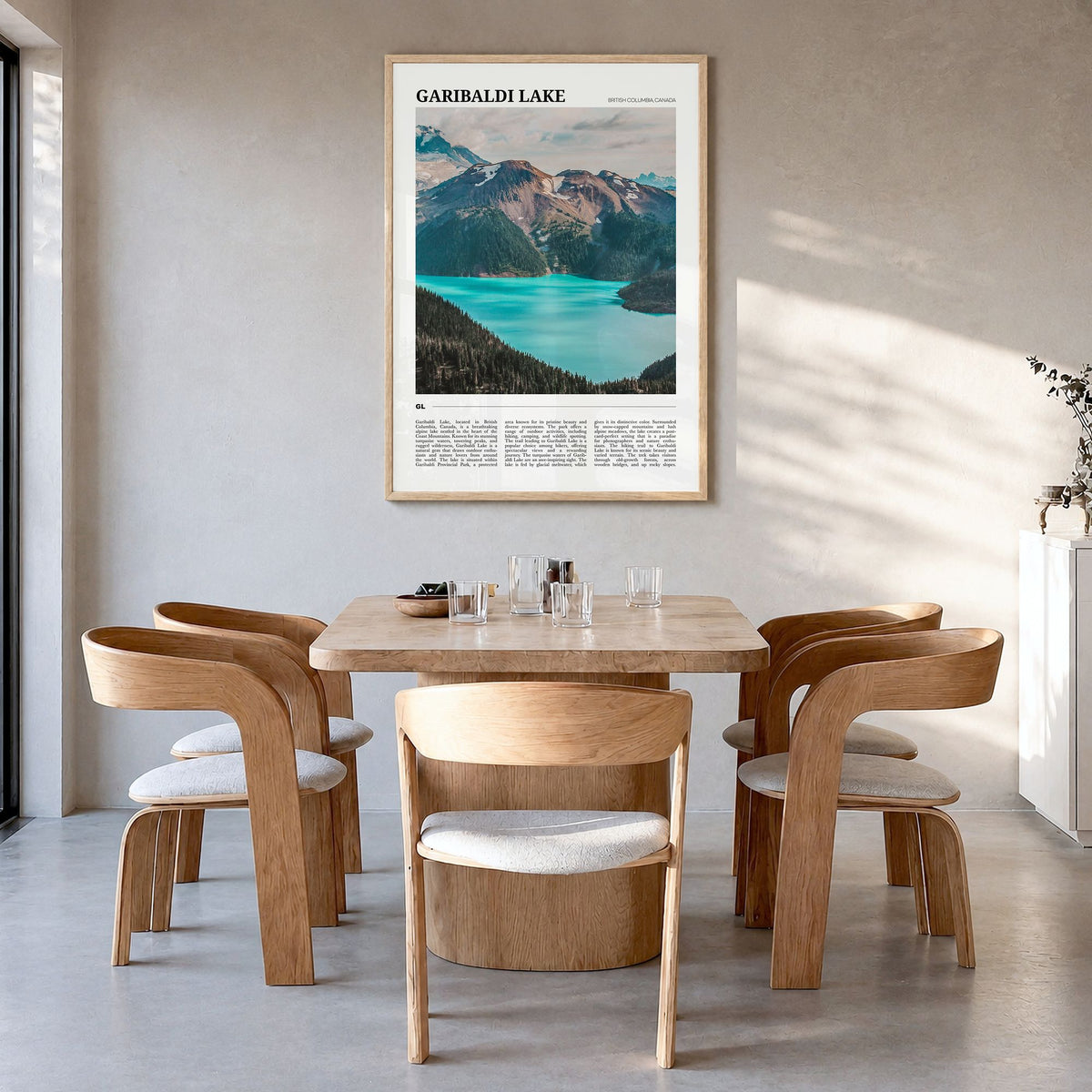 Garibaldi Lake Travel Poster in a natural wood frame, hanging in a dining room