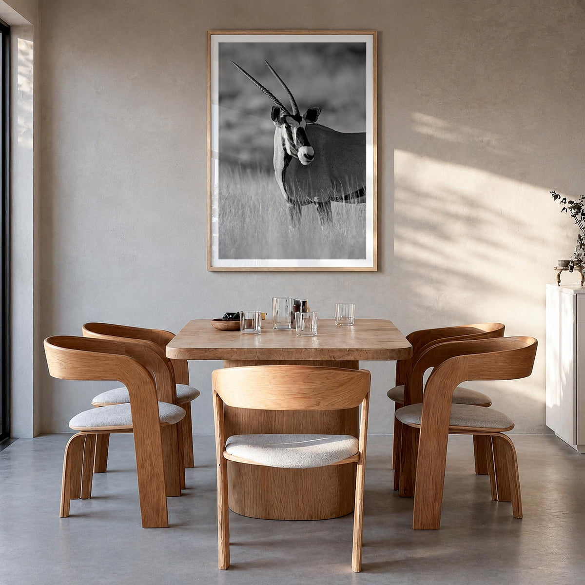Gazella black & white photo poster – vertical wall art in natural wood frame with white border, hanging on wall