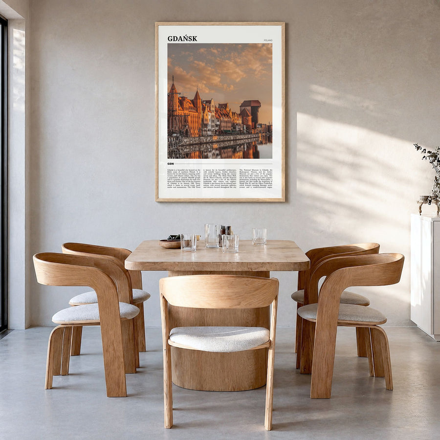 Gdańsk Travel Poster in a natural wood frame, hanging in a dining room