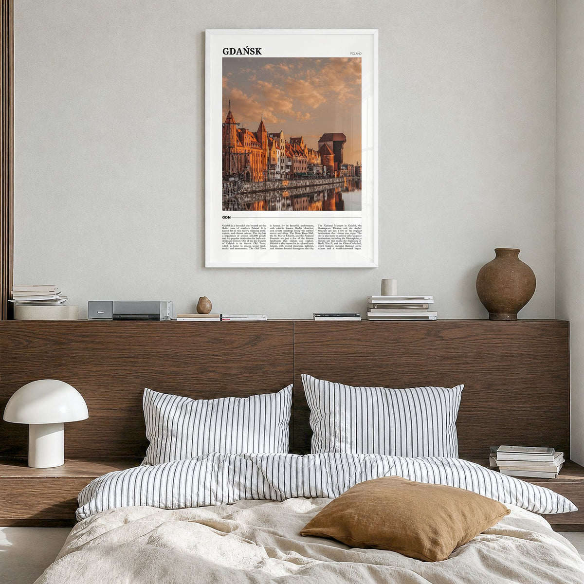 Gdańsk Travel Poster in a white wood frame, hanging in a bedroom