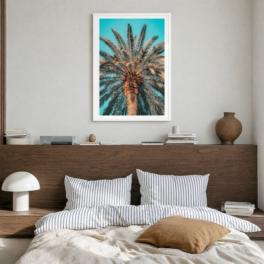 Giant Palm Tree Photo Poster in a white wood frame, hanging in a bedroom, white border