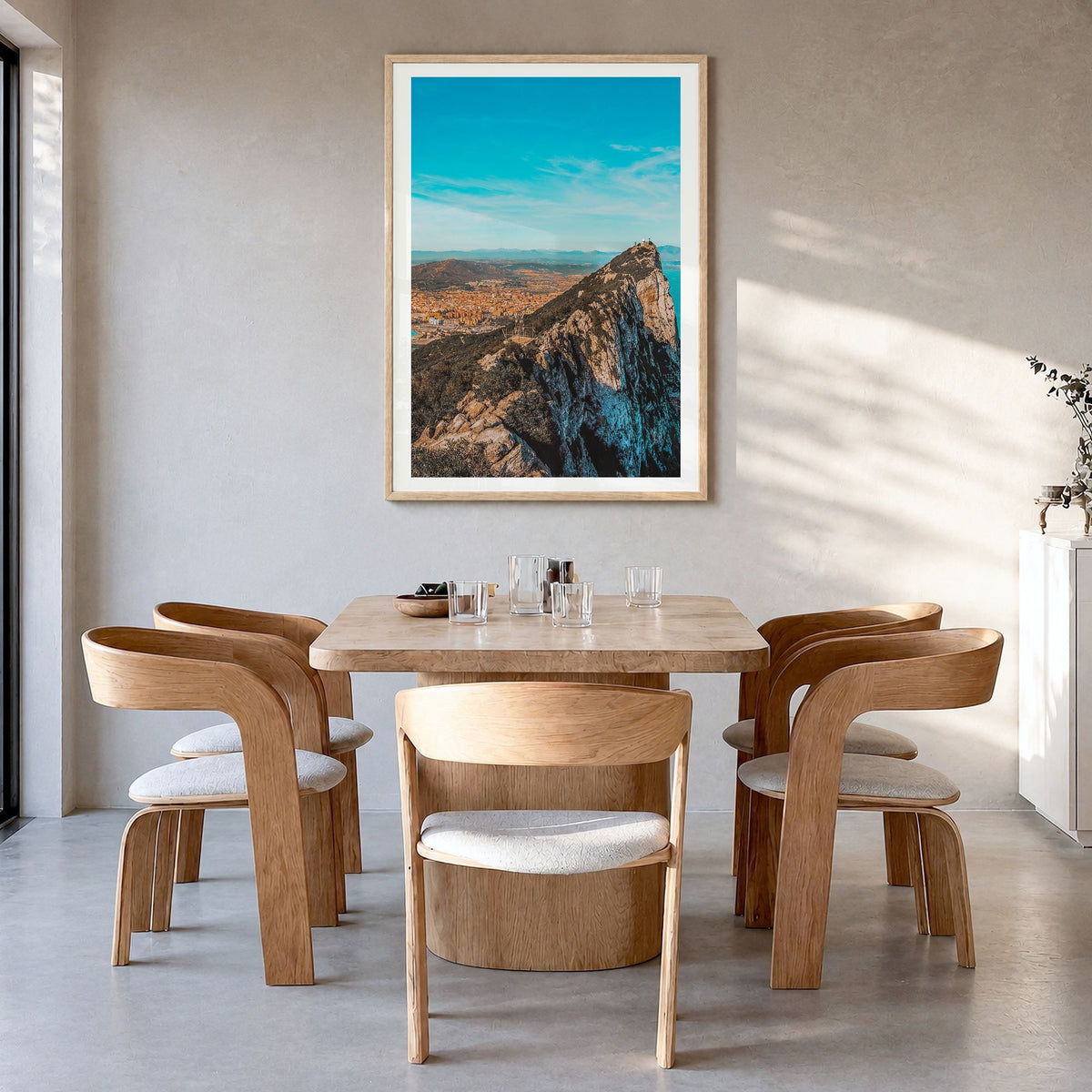 Gibraltar Photo Poster in a natural wood frame, hanging in a dining room, white border