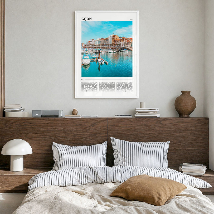 Gijón Travel Poster in a white wood frame, hanging in a bedroom
