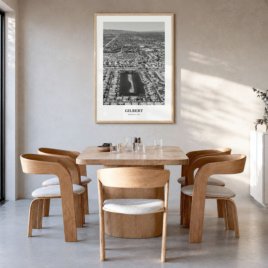 Gilbert Classic Poster in a natural wood frame, hanging in a dining room