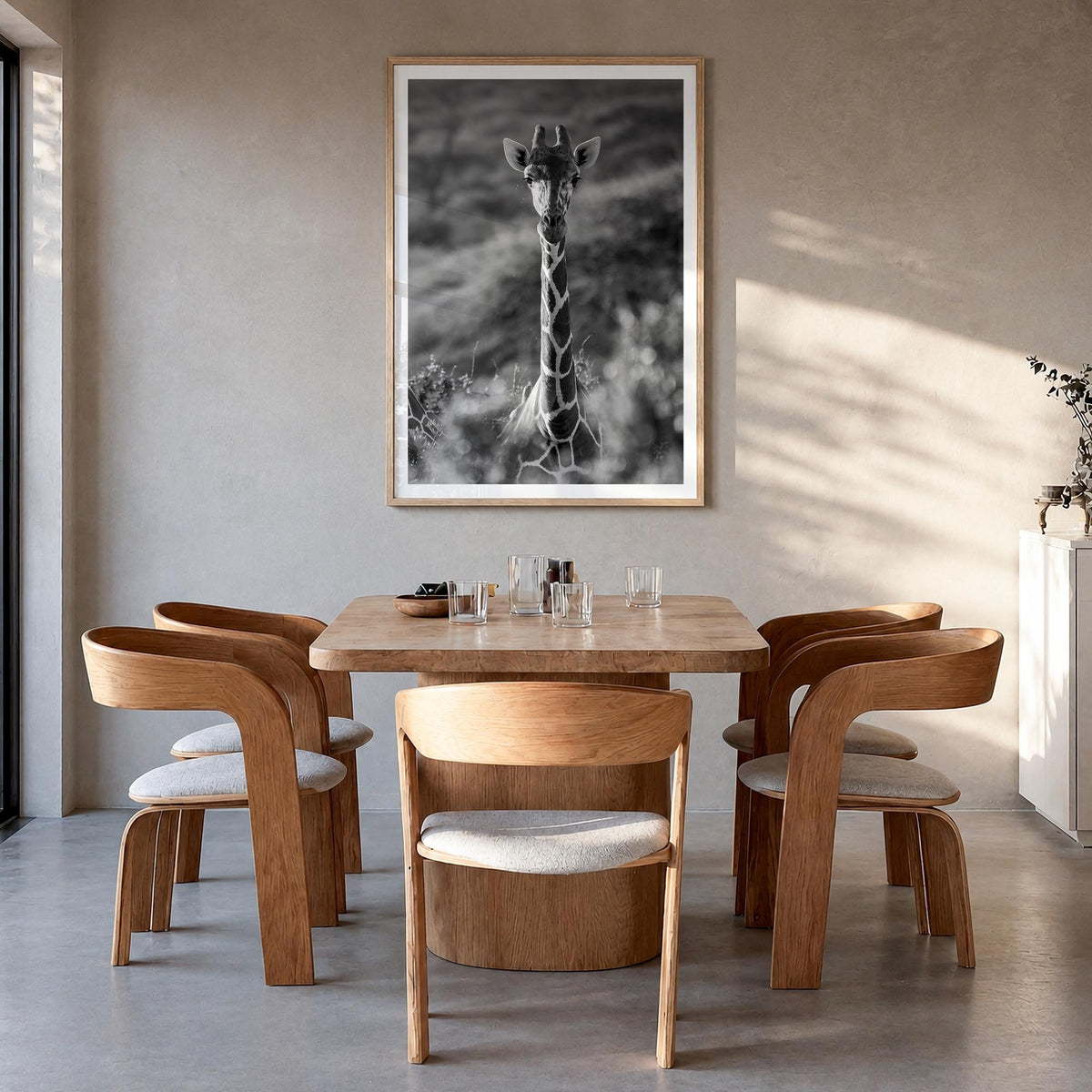 Giraffe no. 1 black & white photo poster – vertical wall art in natural wood frame with white border, hanging on wall