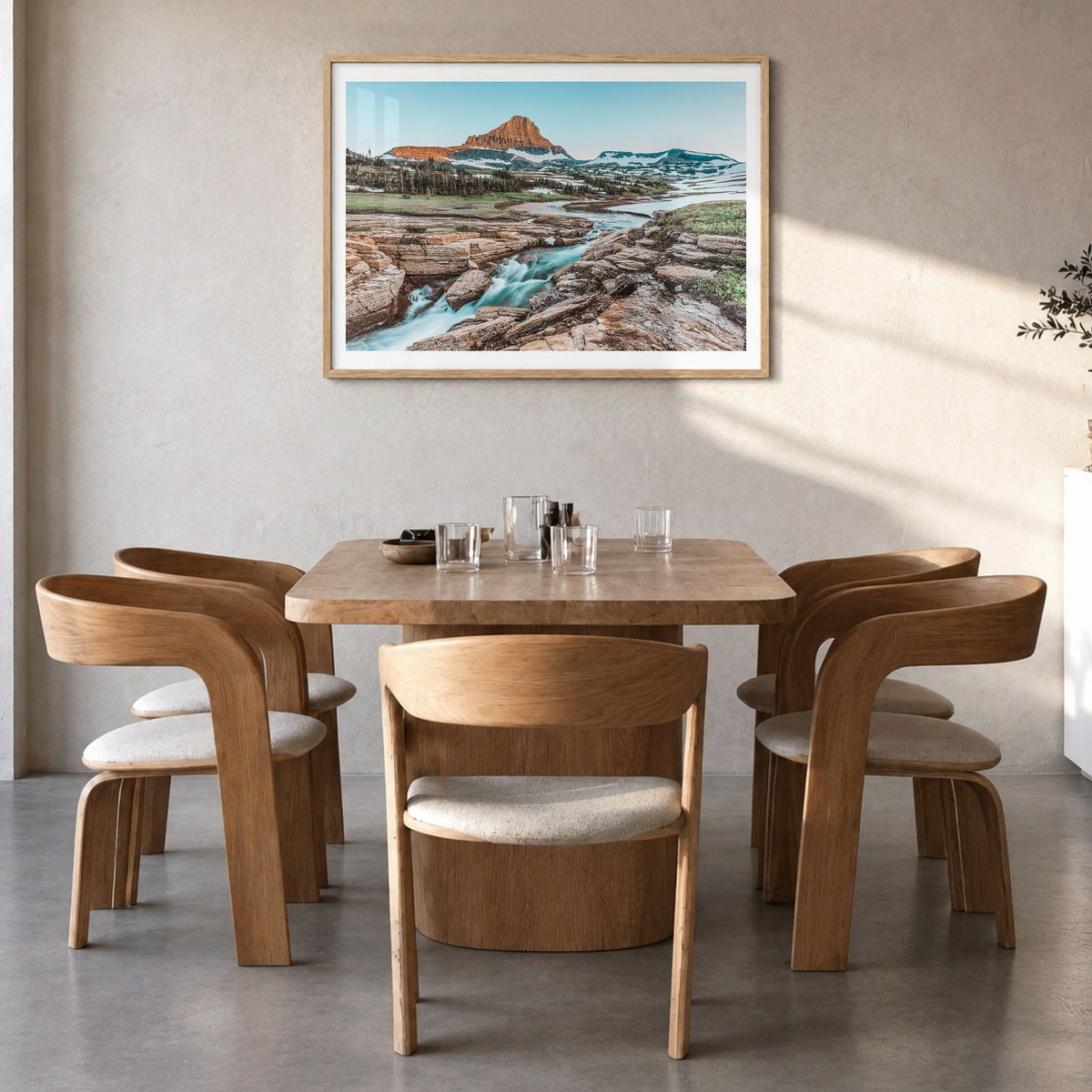 Glacier National Park Photo Poster in a natural wood frame, hanging in a dining room, white border