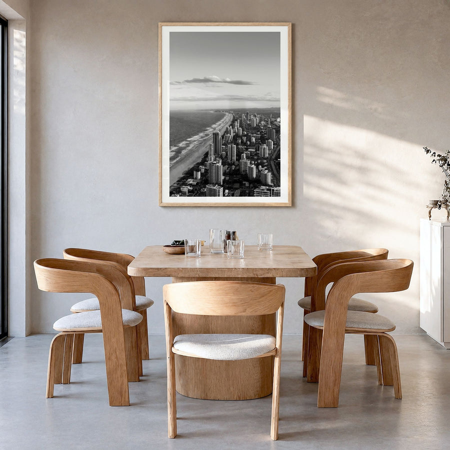 Gold Coast Photo Poster in a natural wood frame, hanging in a dining room, white border