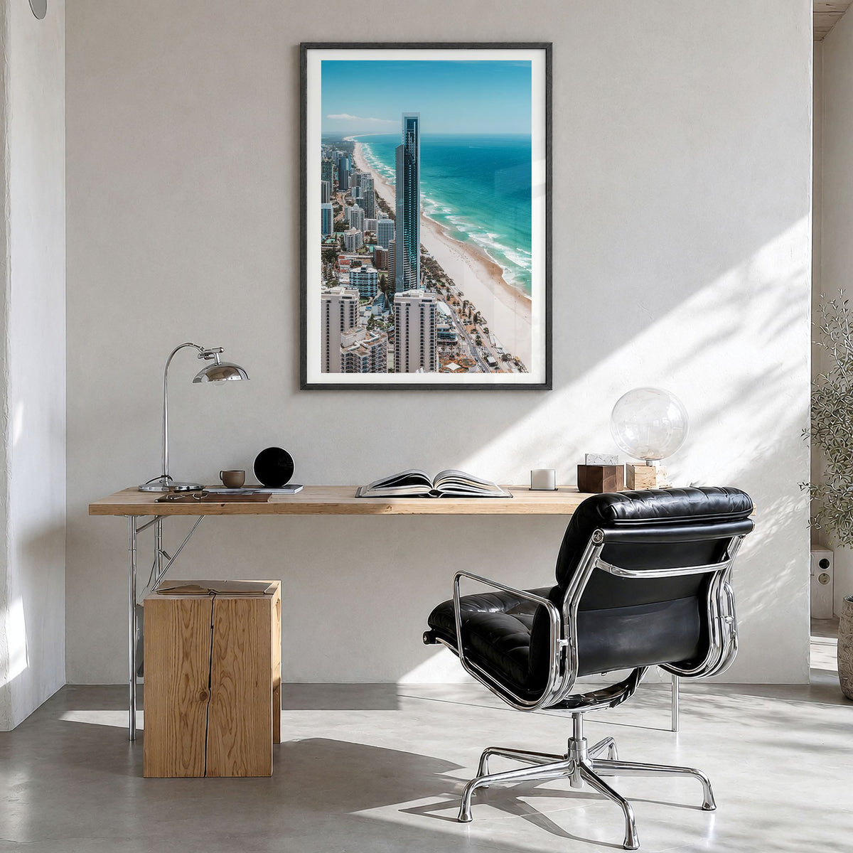 Gold Coast Photo Poster in a black wood frame, hanging in a bright home office, white border
