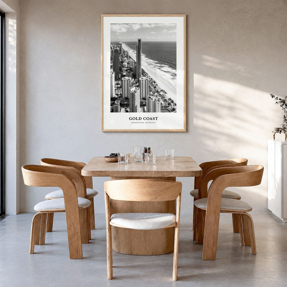 Gold Coast Classic Poster in a natural wood frame, hanging in a dining room