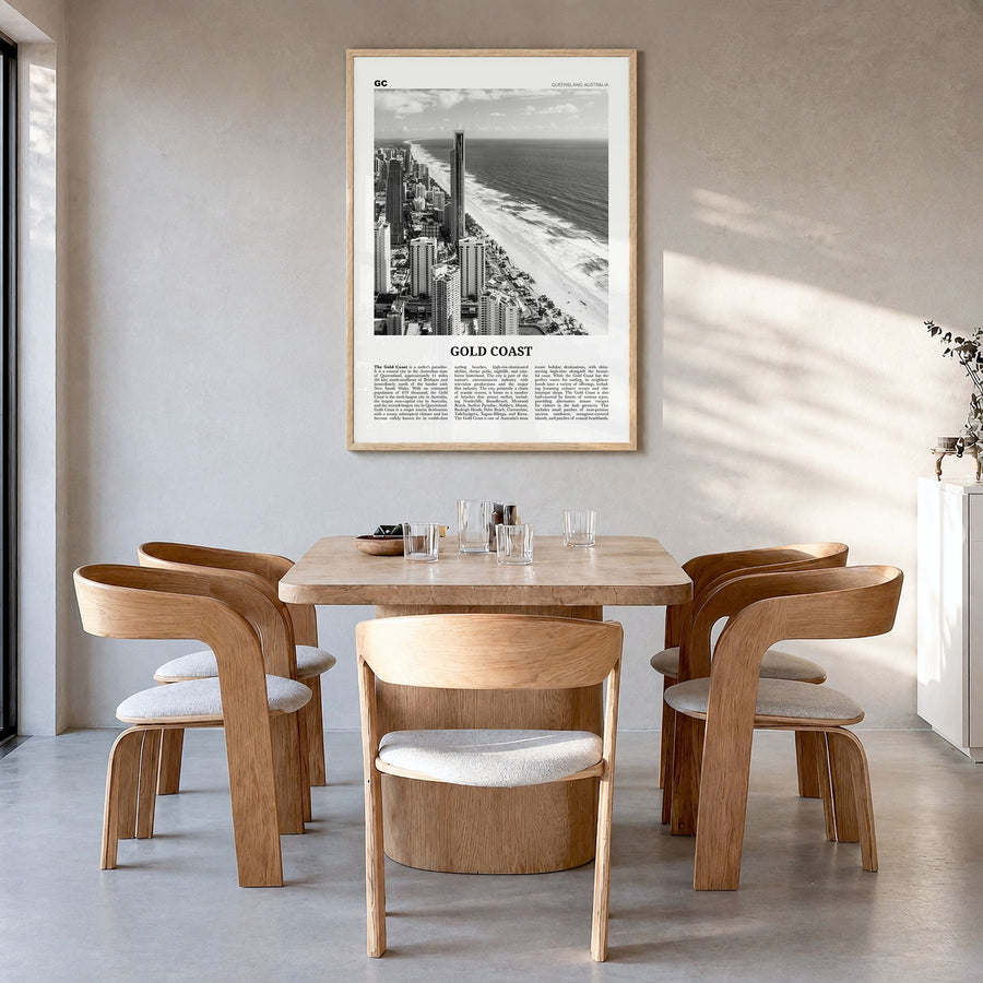 Gold Coast Newspaper Poster in a natural wood frame, hanging in a dining room