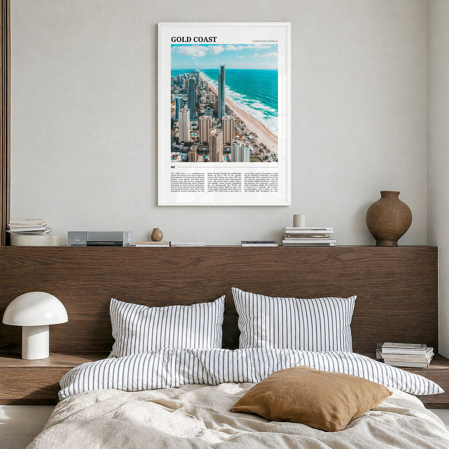 Gold Coast Travel Poster in a white wood frame, hanging in a bedroom