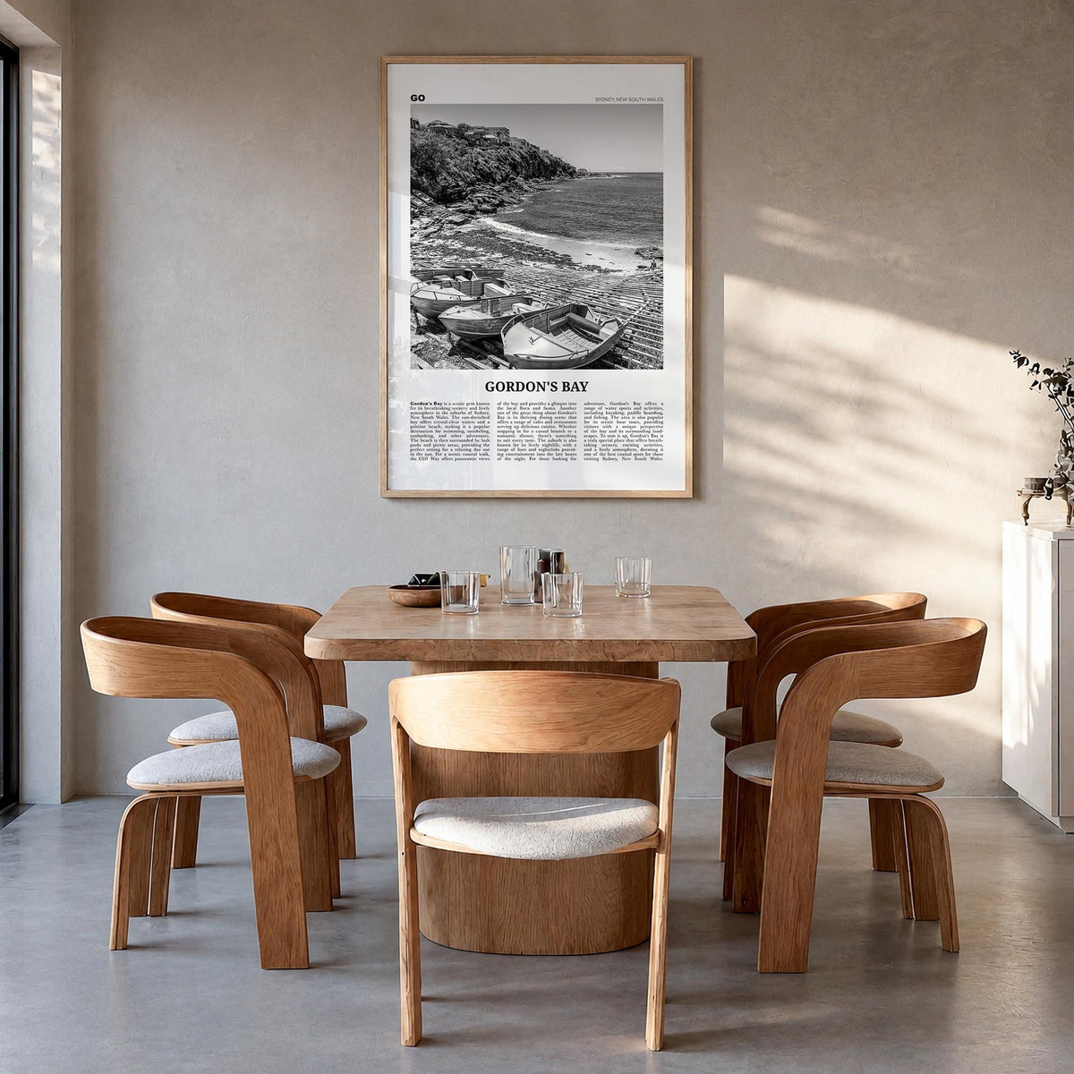 Gordon's Bay black & white newspaper poster of South Africa – vertical wall art in natural wood frame, hanging on wall