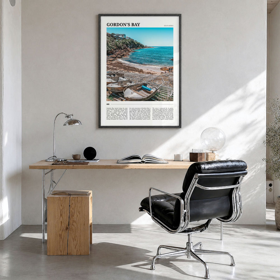 Gordon's Bay Travel Poster in a black wood frame, hanging in a bright home office