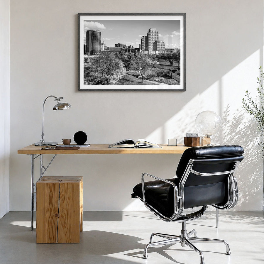 Grand Rapids Photo Poster in a black wood frame, hanging in a bright home office, white border