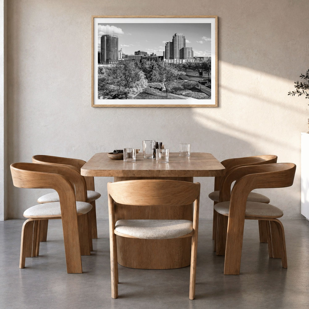 Grand Rapids Photo Poster in a natural wood frame, hanging in a dining room, white border