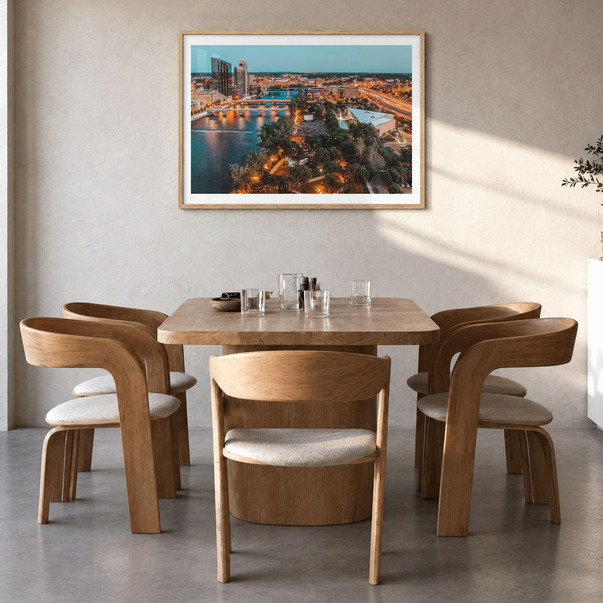 Grand Rapids Photo Poster in a natural wood frame, hanging in a dining room, white border