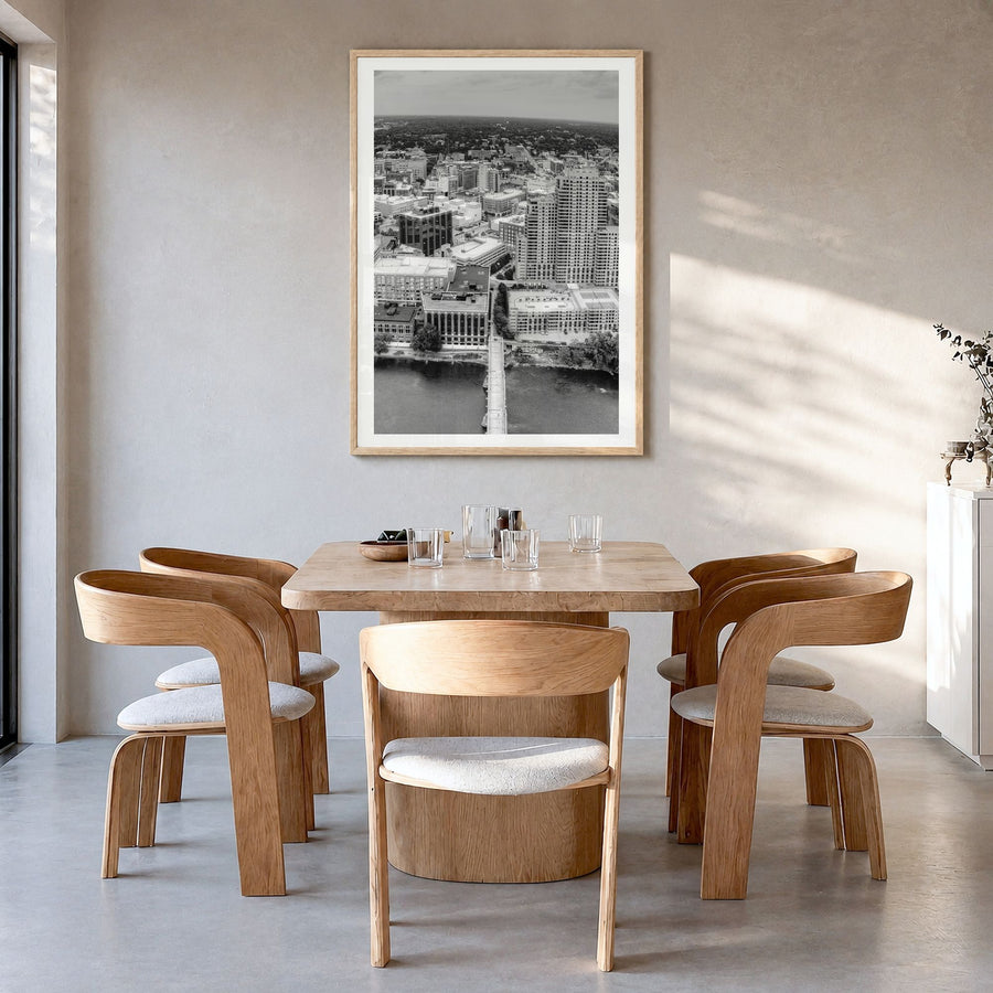Grand Rapids Photo Poster in a natural wood frame, hanging in a dining room, white border