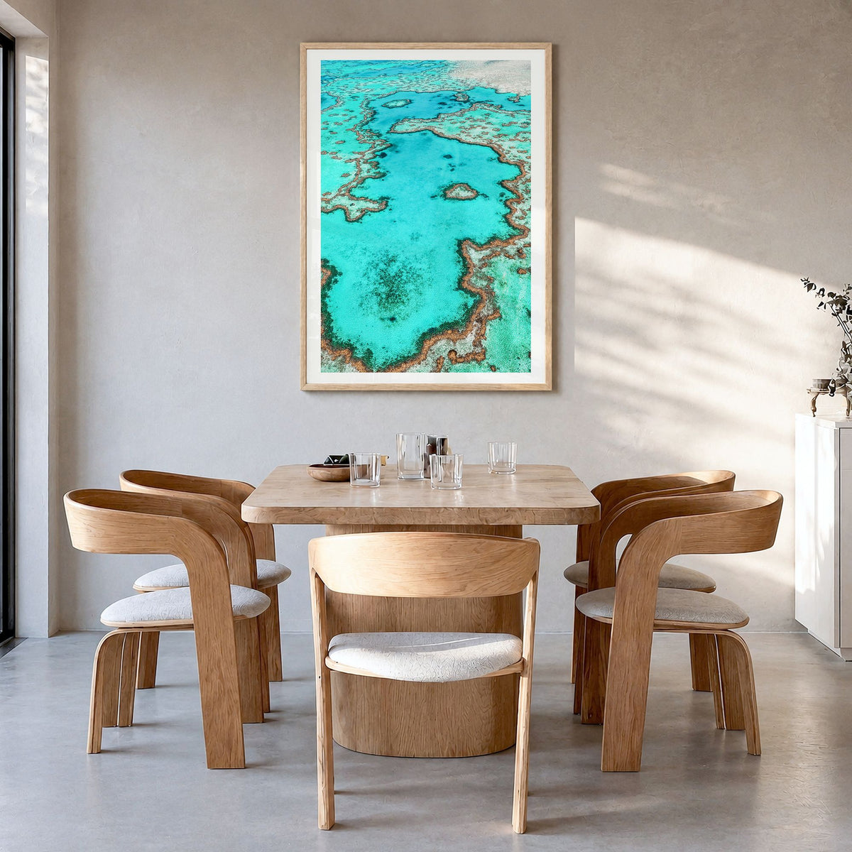 Great Barrier Reef Photo Poster in a natural wood frame, hanging in a dining room, white border