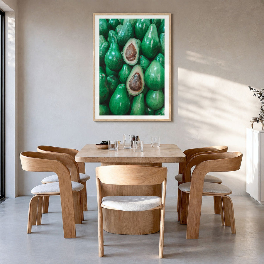 Green Avocados Photo Poster in a natural wood frame, hanging in a dining room, white border