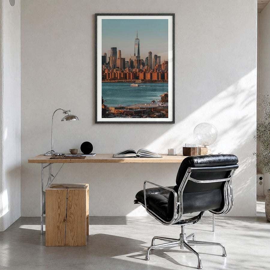 Greenpoint Photo Poster in a black wood frame, hanging in a bright home office, white border