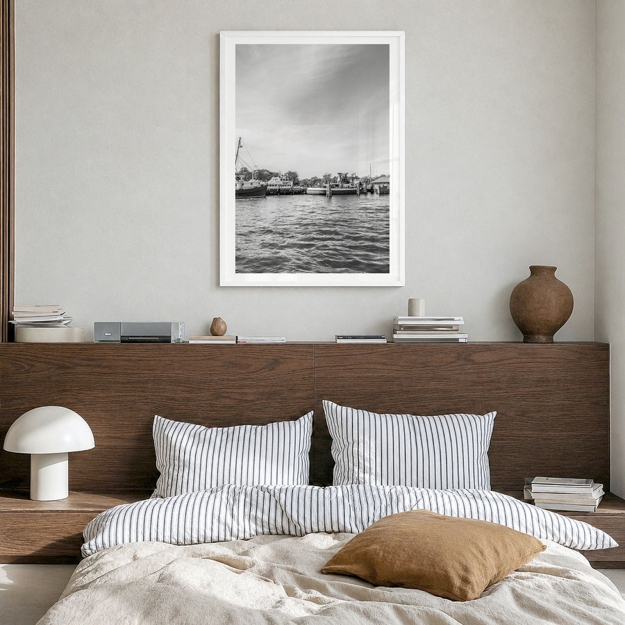 Greenport Photo Poster in a white wood frame, hanging in a bedroom, white border