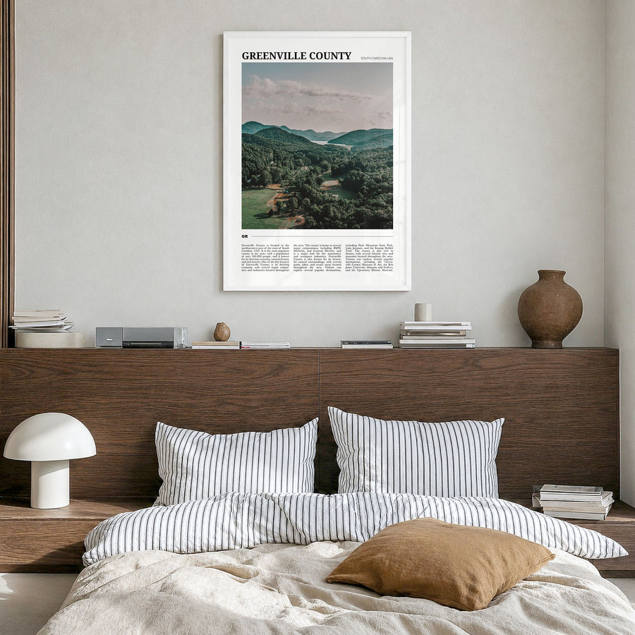 Greenville County Travel Poster in a white wood frame, hanging in a bedroom