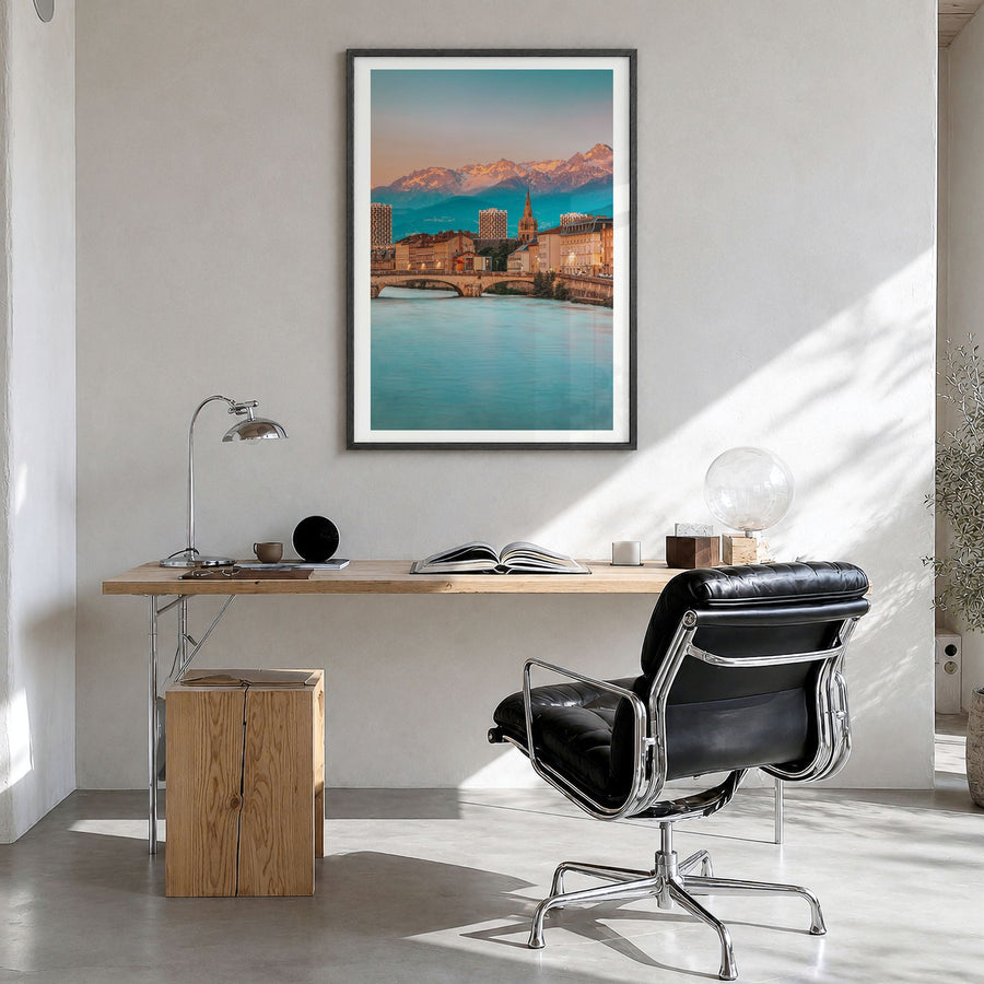 Grenoble Photo Poster in a black wood frame, hanging in a bright home office, white border