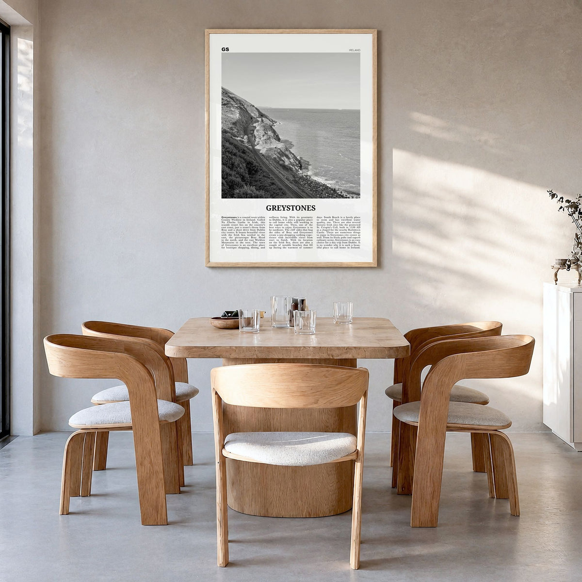Greystones Newspaper Poster in a natural wood frame, hanging in a dining room