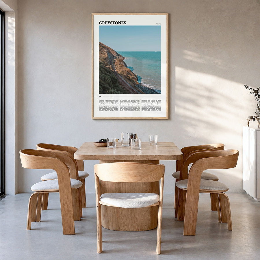 Greystones Travel Poster in a natural wood frame, hanging in a dining room