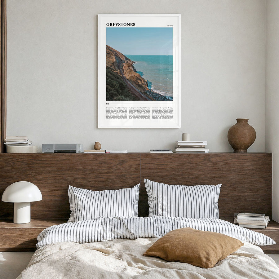Greystones Travel Poster in a white wood frame, hanging in a bedroom