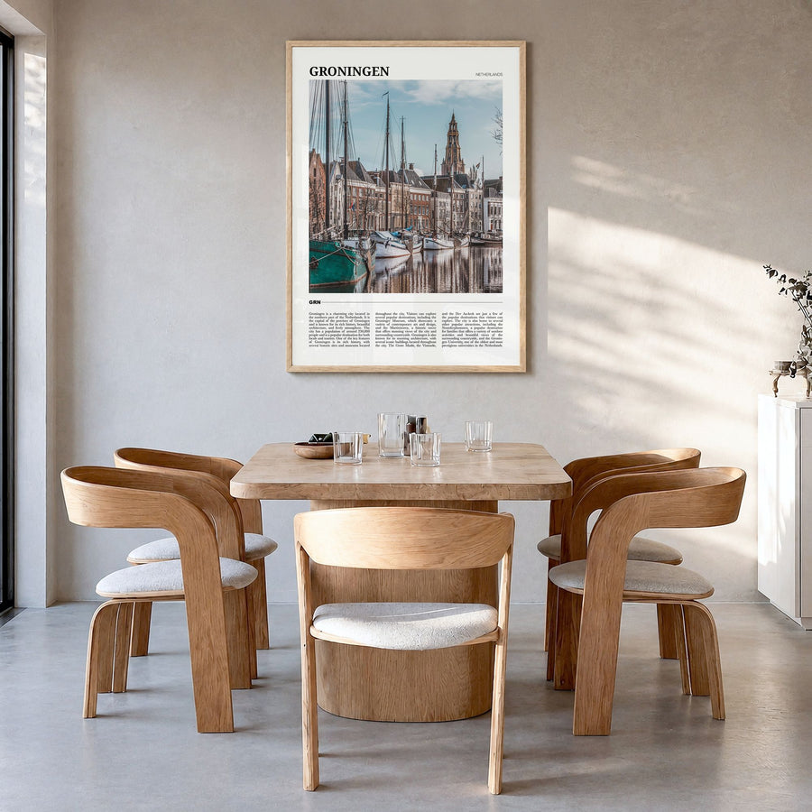 Groningen Travel Poster in a natural wood frame, hanging in a dining room