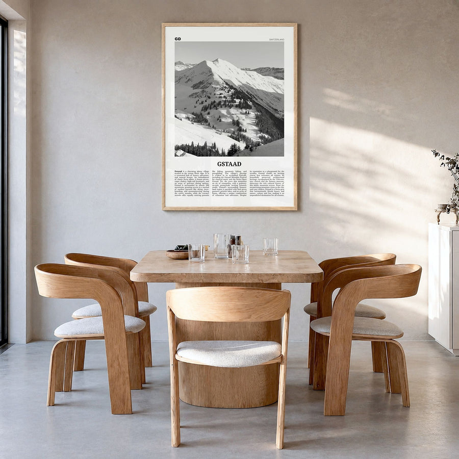 Gstaad Newspaper Poster in a natural wood frame, hanging in a dining room