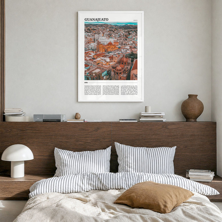 Guanajuato City Travel Poster in a white wood frame, hanging in a bedroom