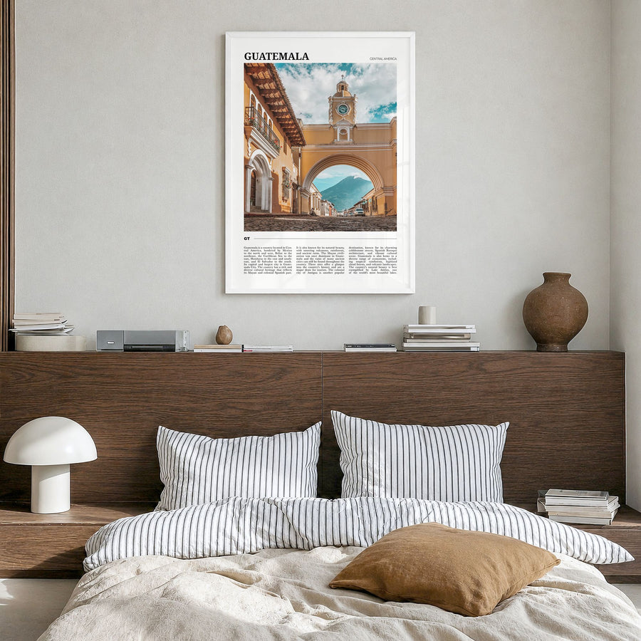 Guatemala Travel Poster in a white wood frame, hanging in a bedroom
