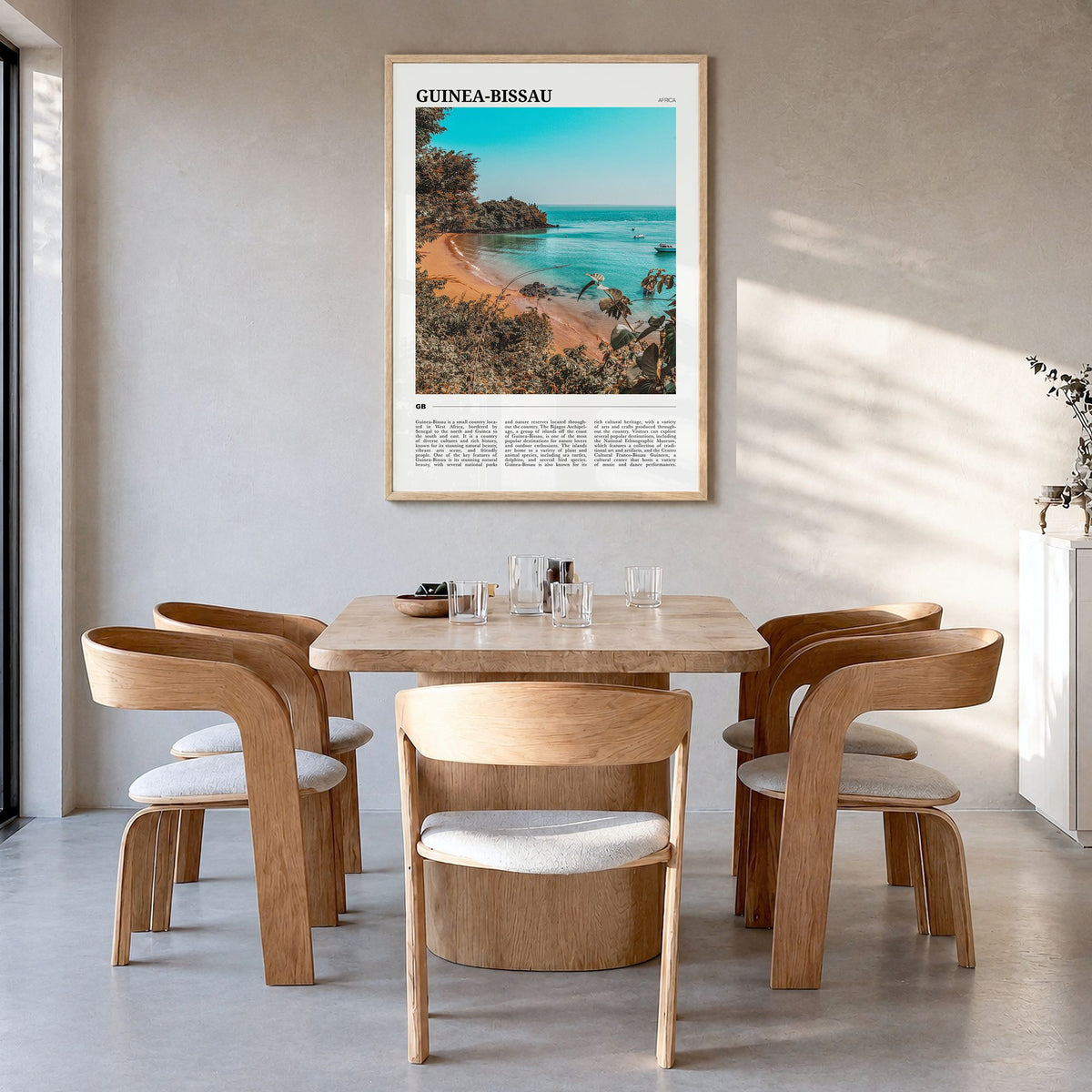 Guinea-Bissau Travel Poster in a natural wood frame, hanging in a dining room