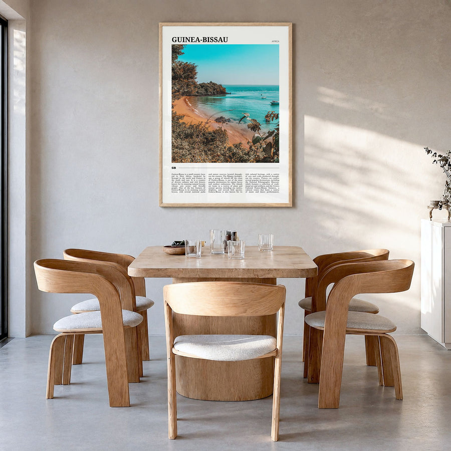 Guinea-Bissau Travel Poster in a natural wood frame, hanging in a dining room