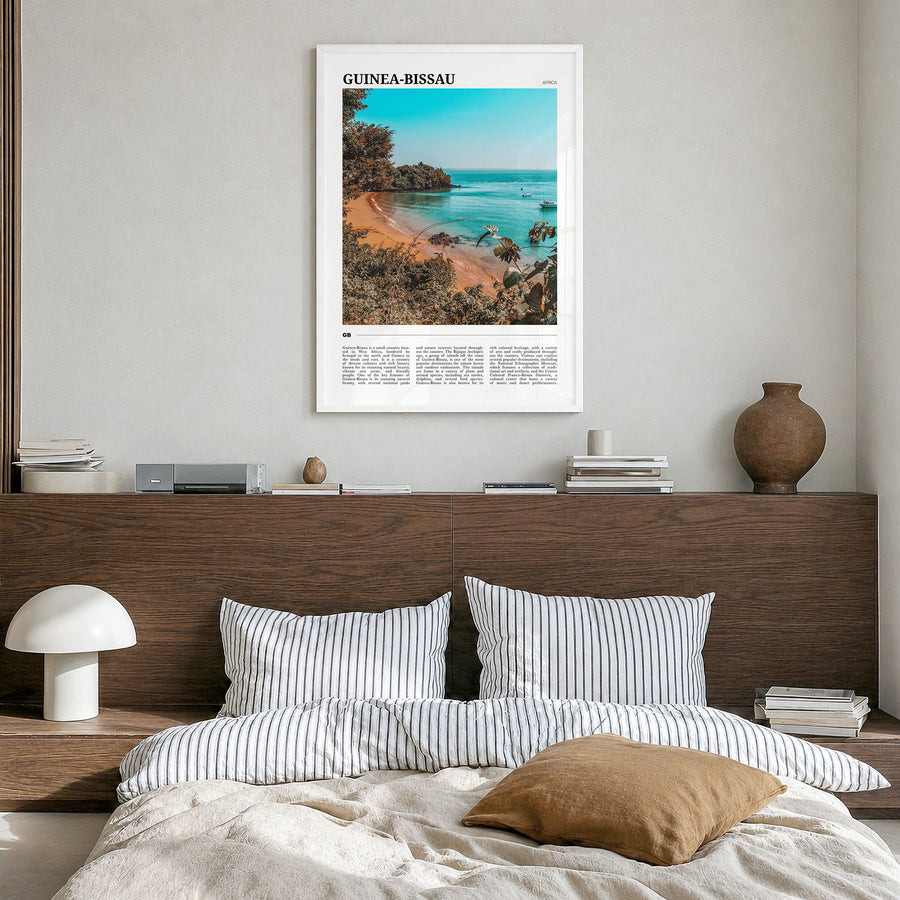 Guinea-Bissau Travel Poster in a white wood frame, hanging in a bedroom