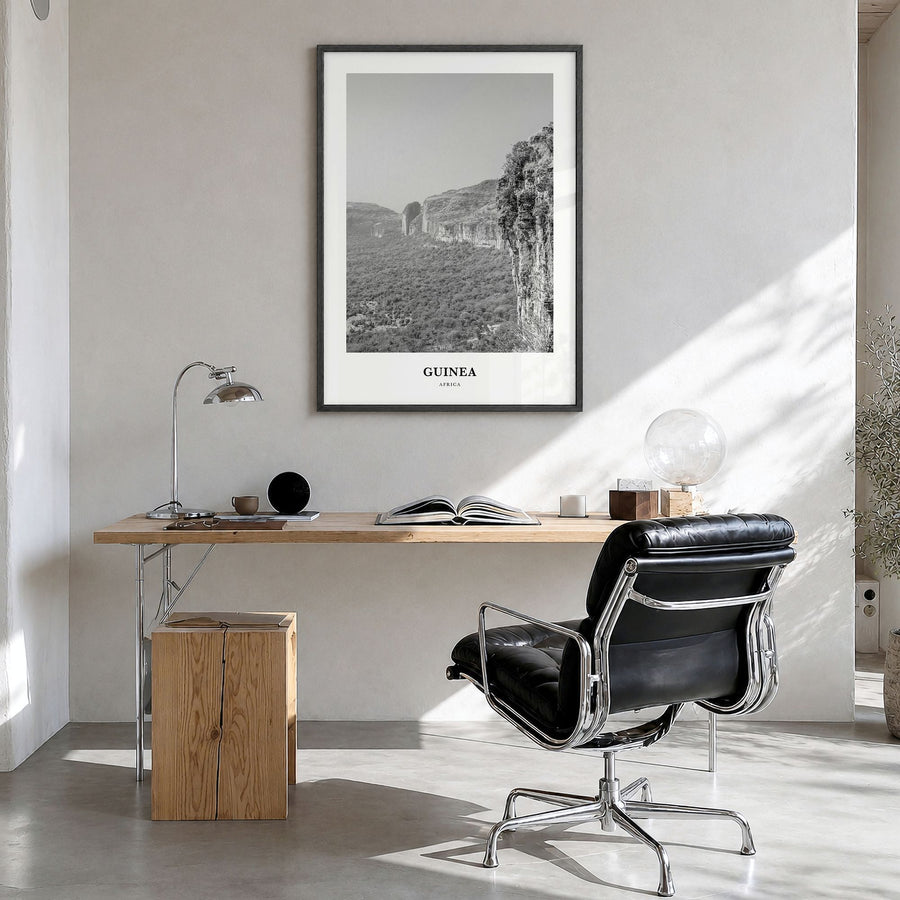 Guinea Classic Poster in a black wood frame, hanging in a bright home office